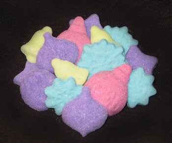 Tea sugars shaped like snowflakes, bells, and ornaments in fuchsia, turquoise, lime, and purple