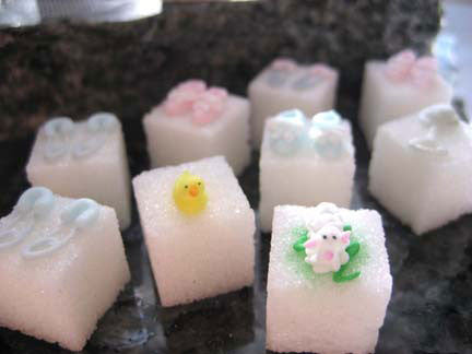 Decorated sugar cubes wtih baby booties, diaper pins, rattles, lambs, and ducks