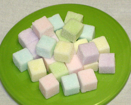Mini-sized sugar cubes in pastel colors of green, blue, purple, pink, and yellow